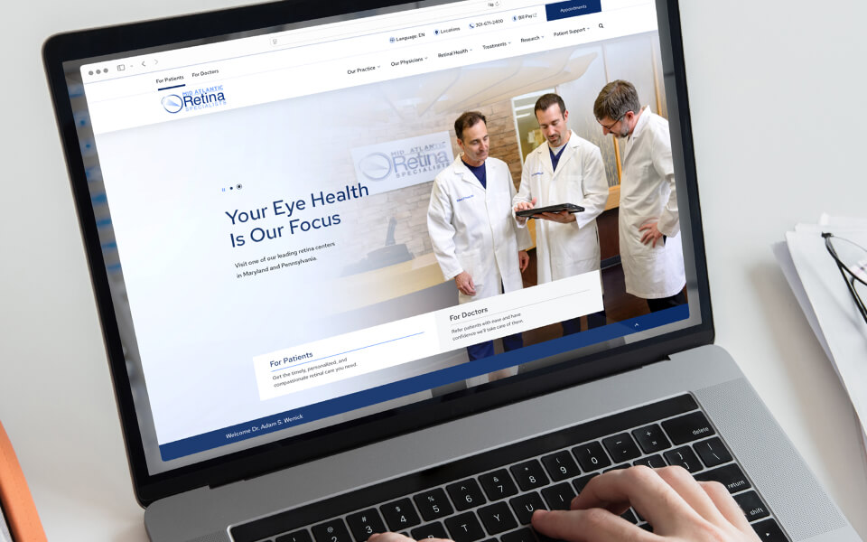 Person browsing Mid Atlantic Retina Specialists website on a laptop.